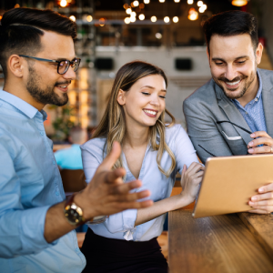 happy coworkers looking at tablet